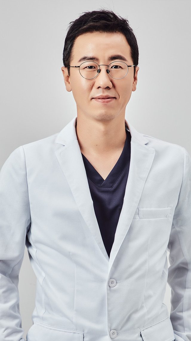 Portrait of a male doctor wearing glasses and a white coat